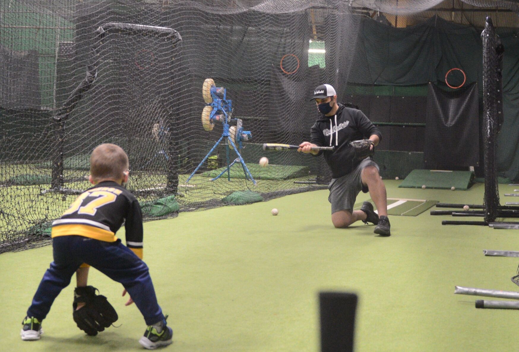 Mike Massery hits a ball while working on fielding